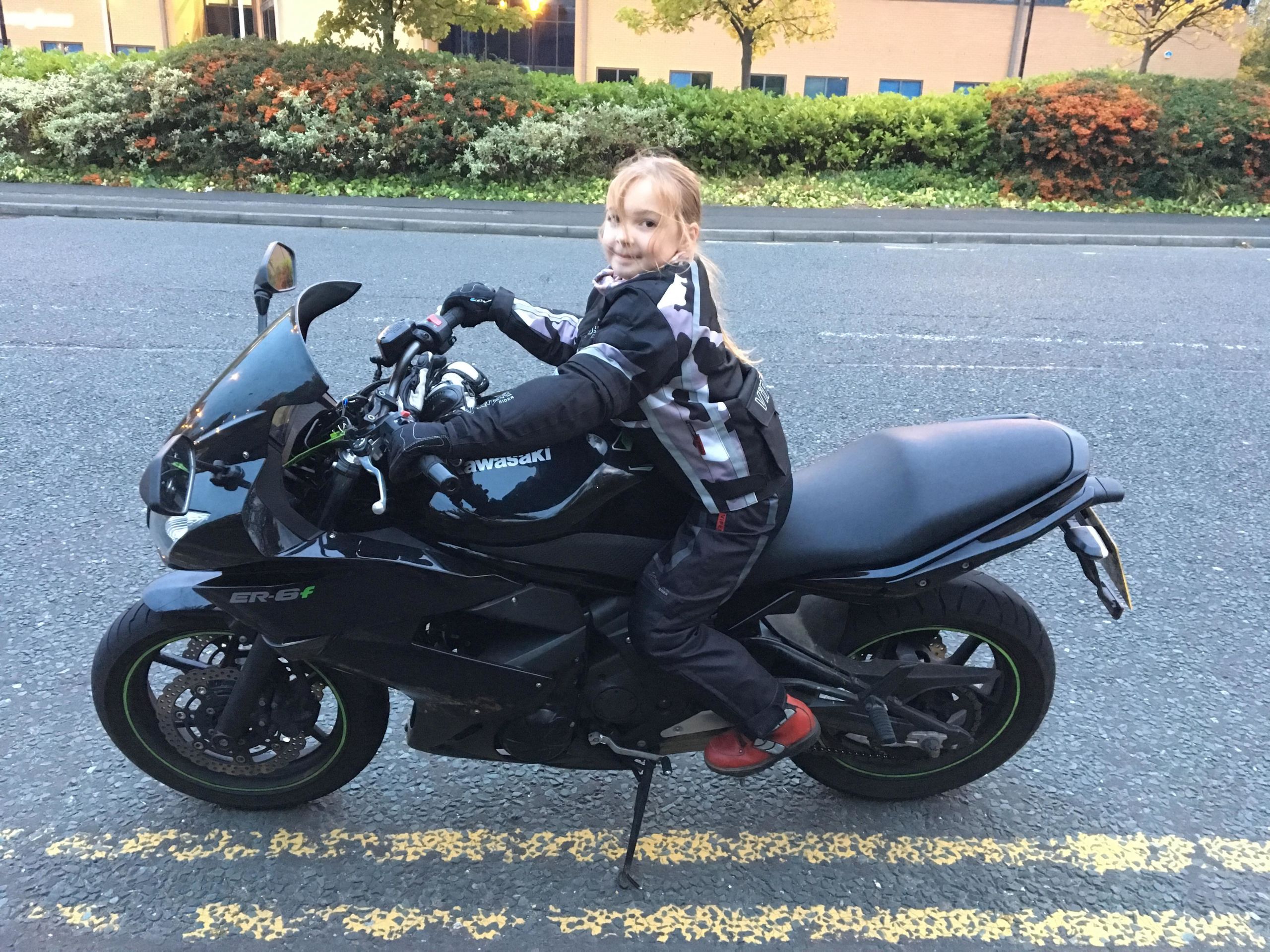Young Pippa posing on her mothers bike